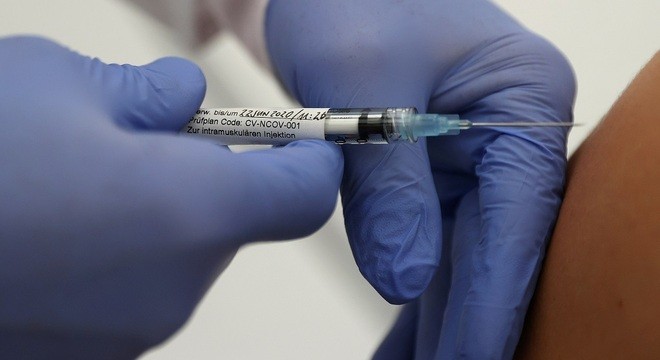 FILE PHOTO: Professor Gottfried Kremsner injects a vaccination against the coronavirus disease (COVID-19) from German biotechnology company CureVac to a volunteer at the start of a clinical test series at his tropical institute of the university clinic in